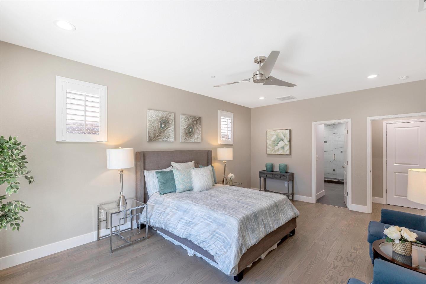 1106 Sprig Way Gilroy, CA 95020 - Photo 16 of 27 a bedroom with a large bed and a chandelier