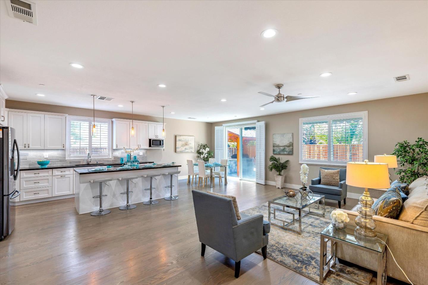 1106 Sprig Way Gilroy, CA 95020 - Photo 5 of 27 a large kitchen with lots of counter space and dining table wooden floor
