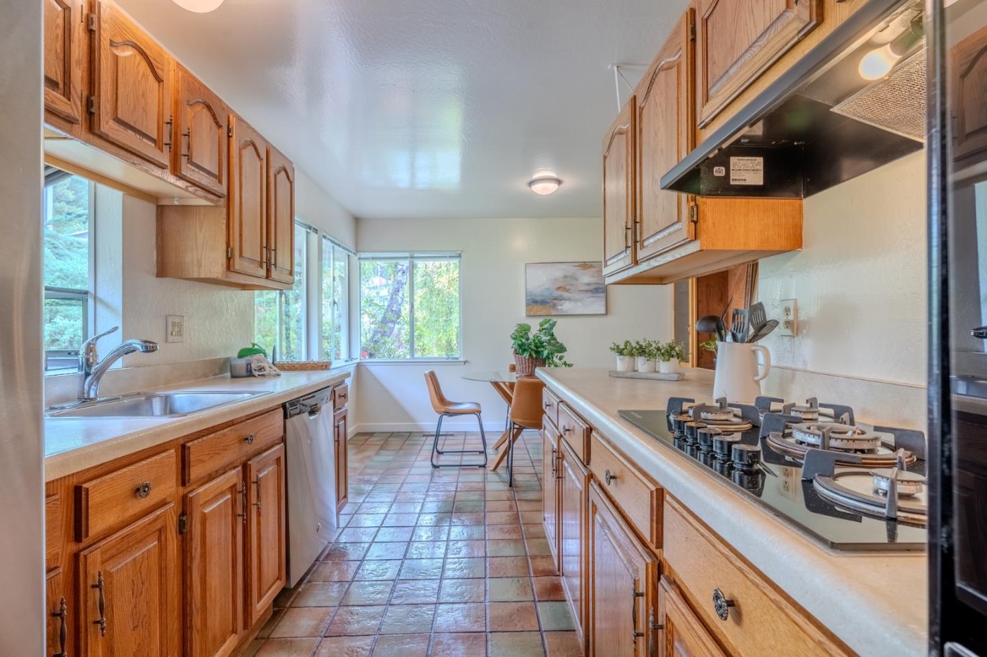 1031 Yosemite Drive Pacifica, CA 94044 - Photo 15 of 40 a kitchen with stainless steel appliances a sink stove and cabinets