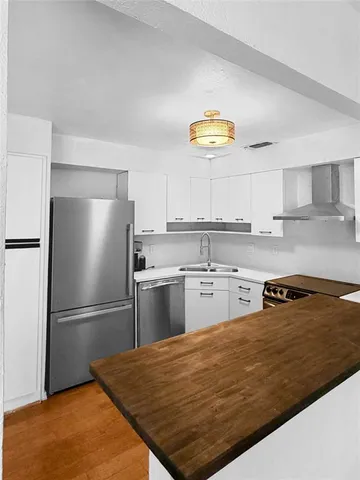 a bedroom with a bed and a kitchen