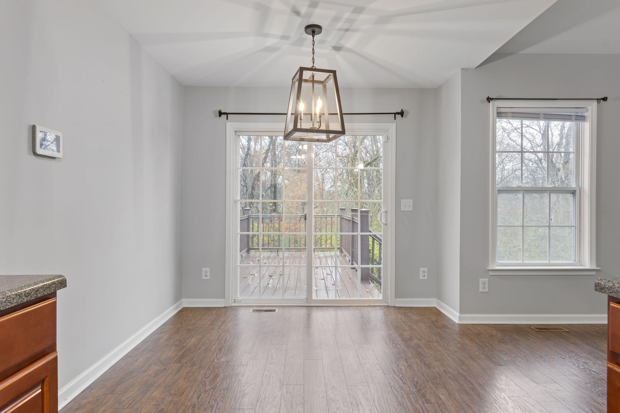 1112 Golf View Way Spring Hill, TN 37174 - Photo 15 of 47 an empty room with wooden floor exposed radiator and windows