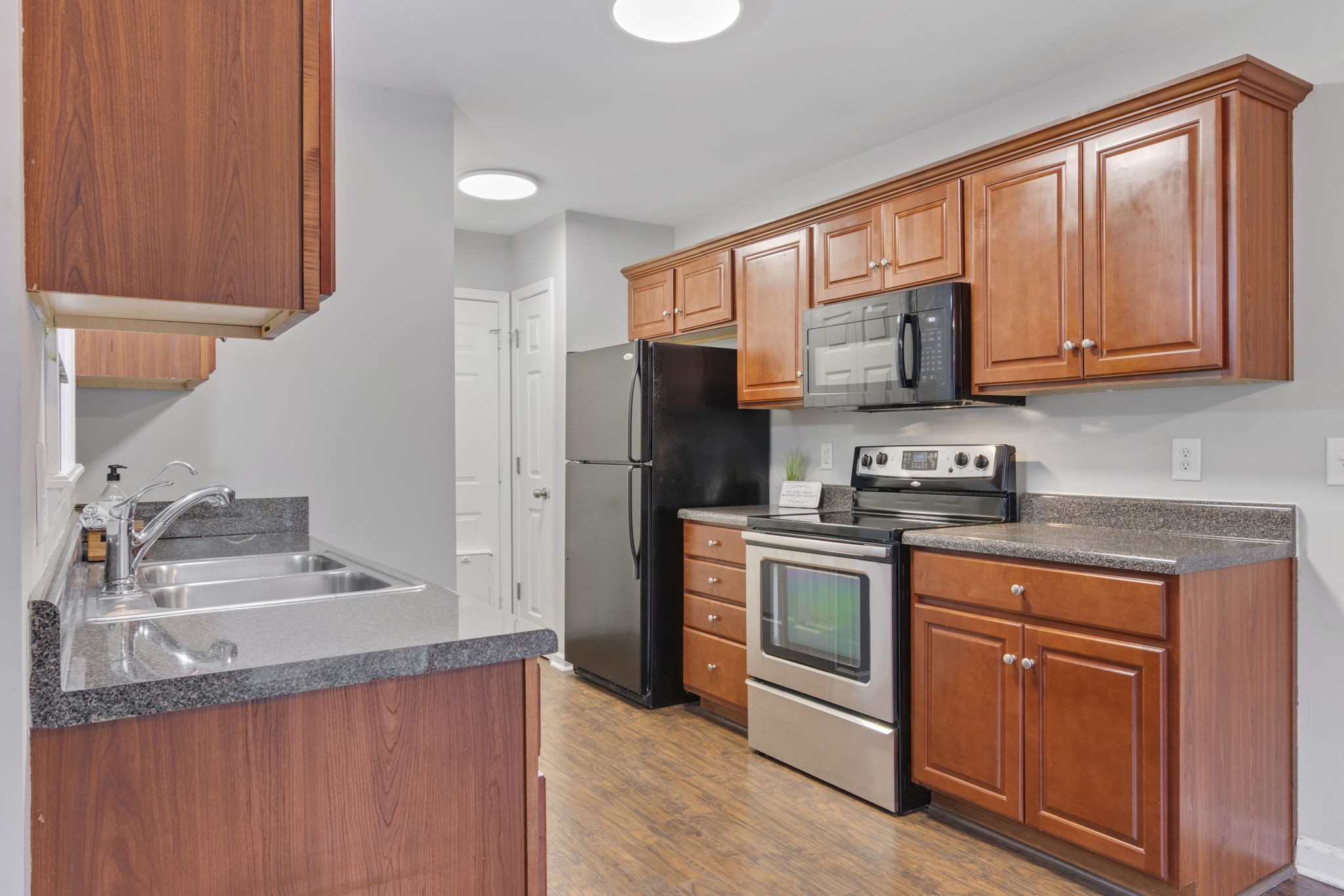 1112 Golf View Way Spring Hill, TN 37174 - Photo 18 of 47 a kitchen with stainless steel appliances granite countertop a refrigerator sink and stove