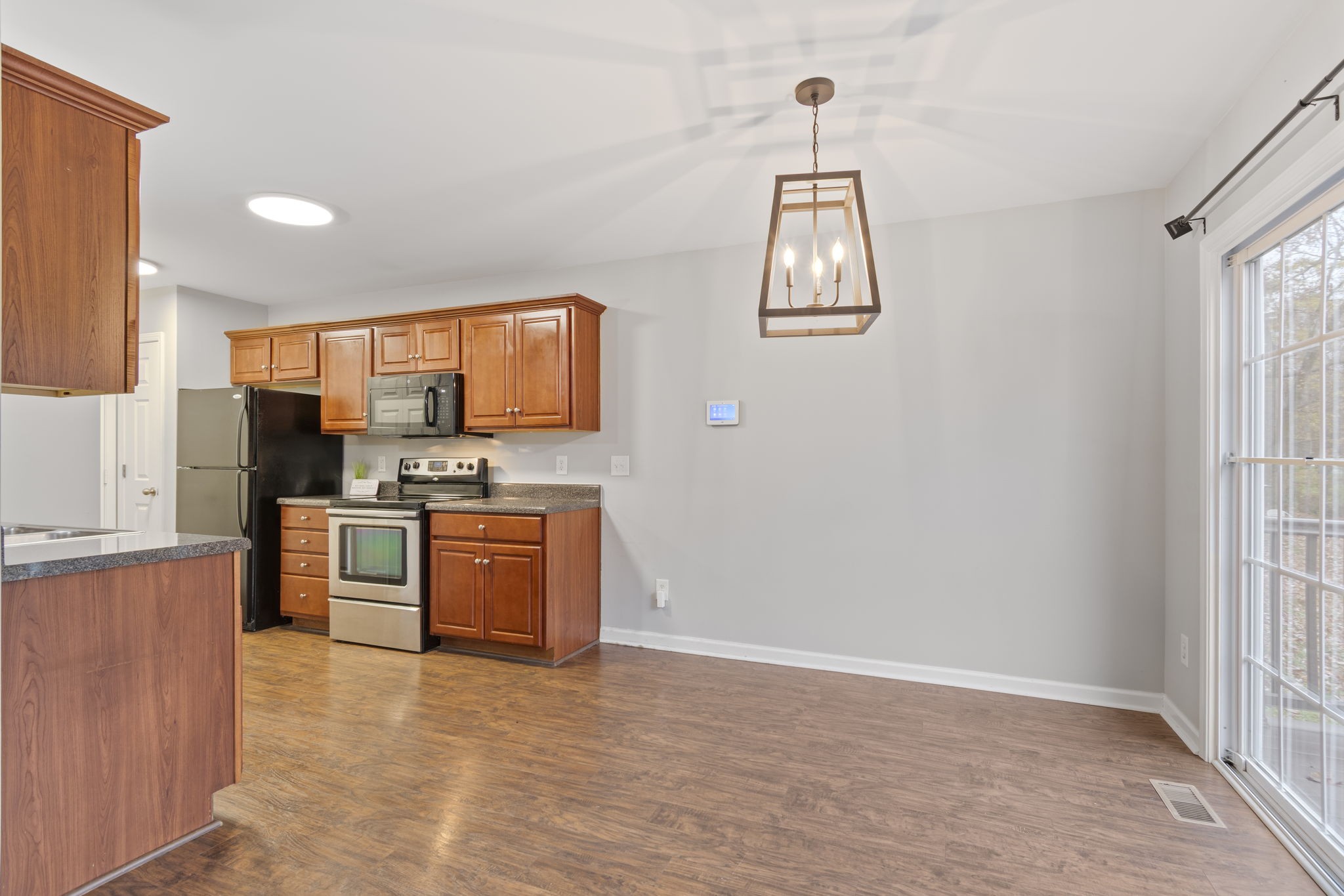1112 Golf View Way Spring Hill, TN 37174 - Photo 19 of 47 a kitchen with stainless steel appliances a refrigerator sink and stove