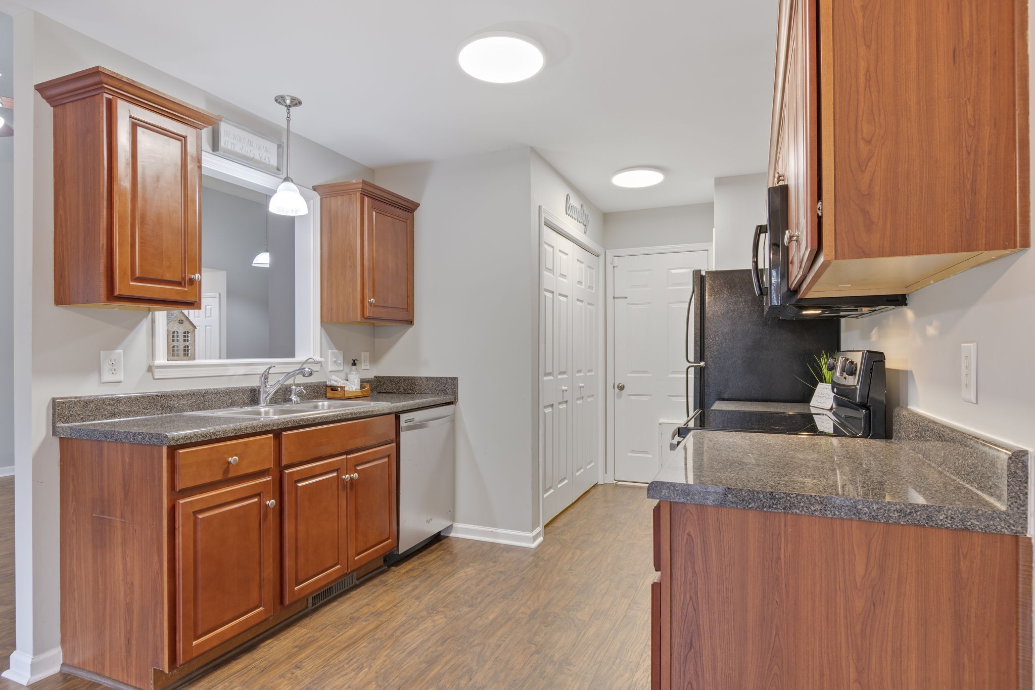 1112 Golf View Way Spring Hill, TN 37174 - Photo 20 of 47 a kitchen with stainless steel appliances granite countertop a sink a stove and a wooden cabinets