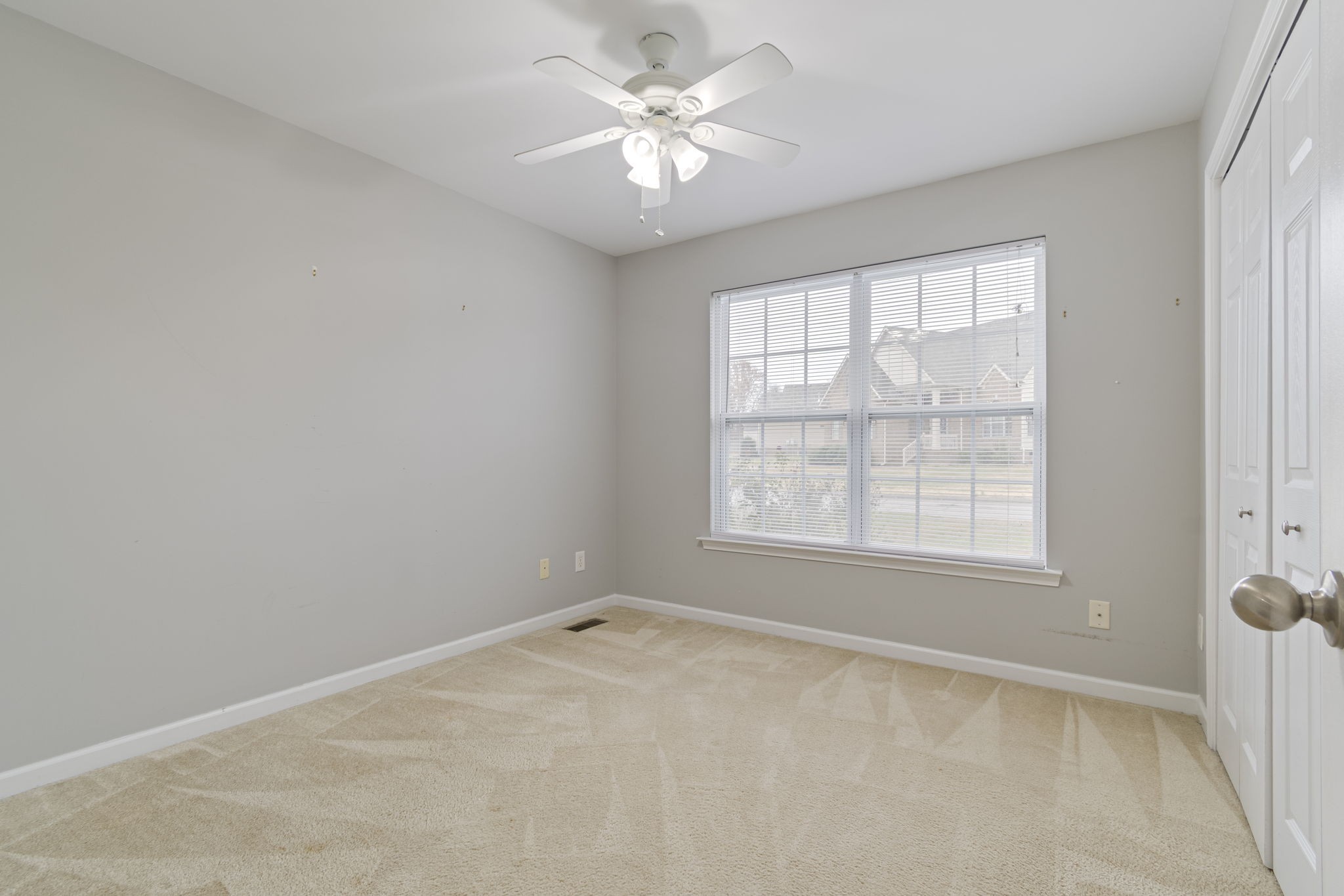 1112 Golf View Way Spring Hill, TN 37174 - Photo 32 of 47 an empty room with a window and a fan