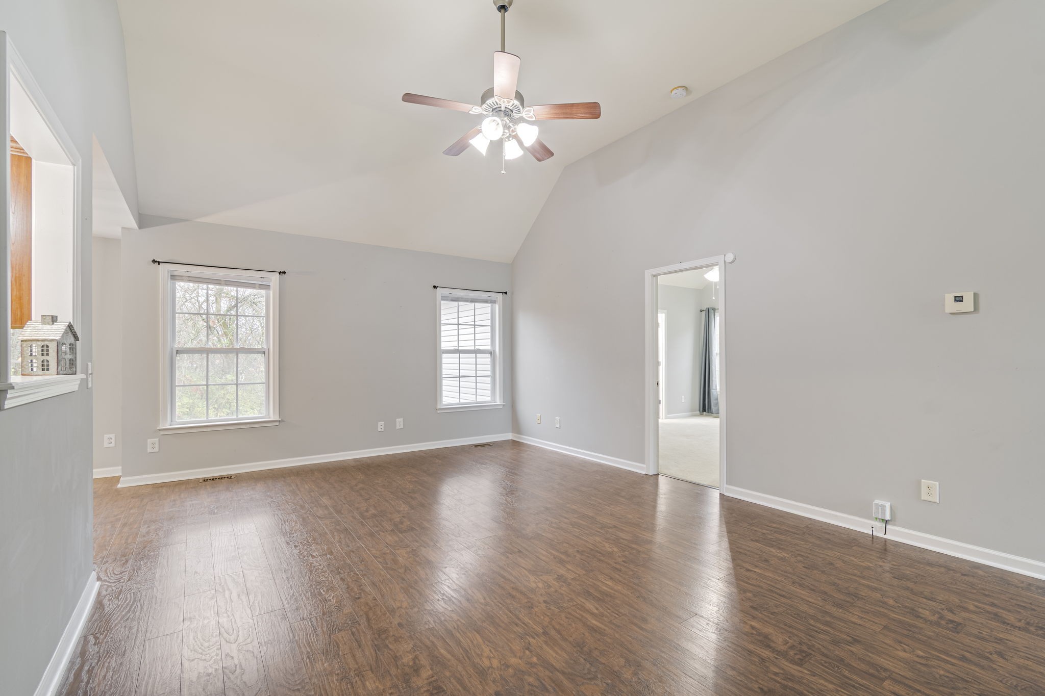 1112 Golf View Way Spring Hill, TN 37174 - Photo 10 of 47 a view of an empty room with wooden floor and a window