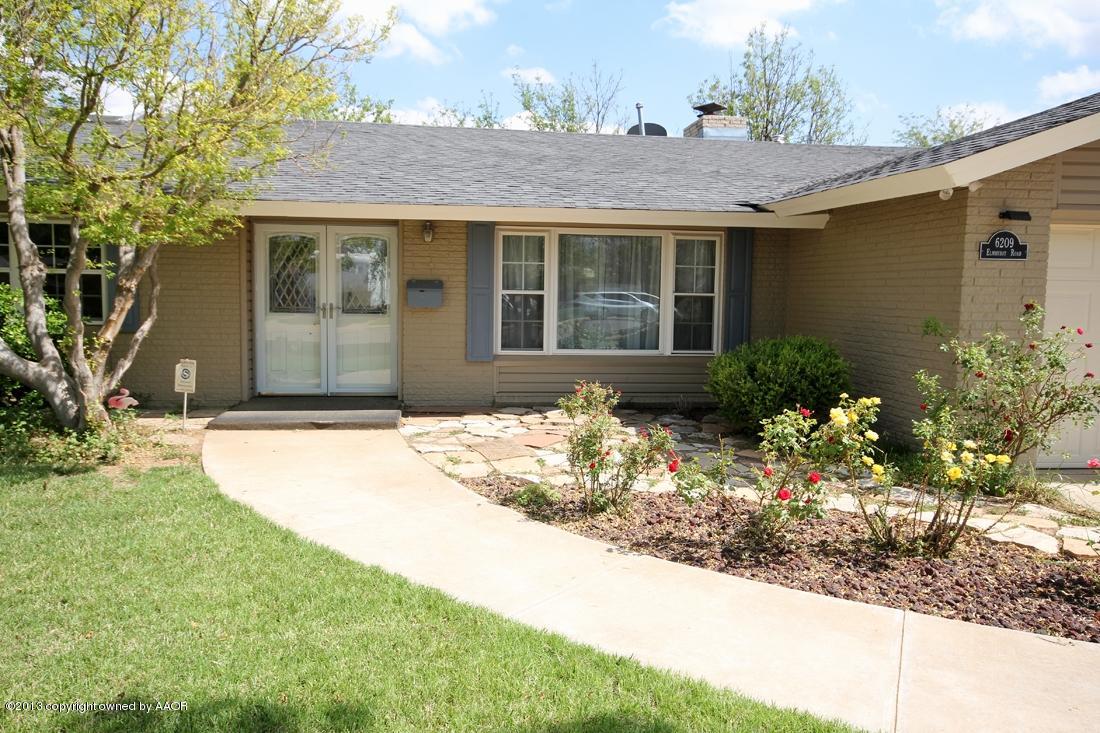 6209 Elmhurst Road Amarillo, TX 79106 - Photo 1 of 43 Front View with Flowers and Trees