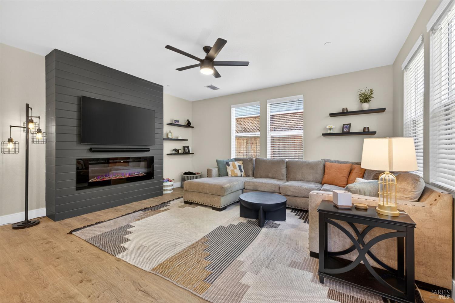 2215-2217 Versaro Drive Santa Rosa, CA 95403 - Photo 13 of 45 a living room with furniture a flat screen tv and a fireplace