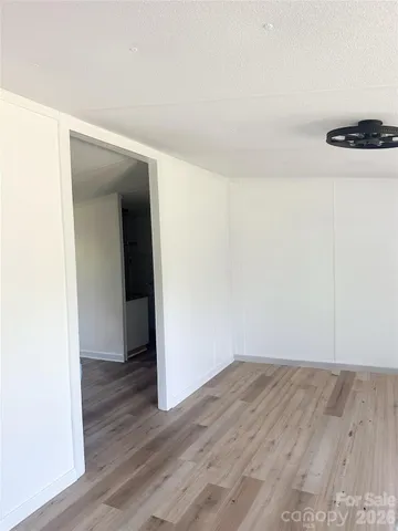 an empty room with wooden floor and closet