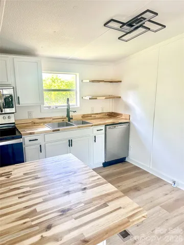 a kitchen with a sink cabinets and window