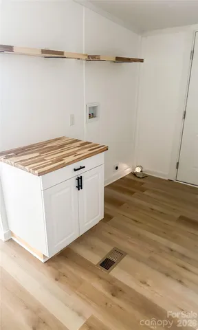a view of a kitchen with wooden floor