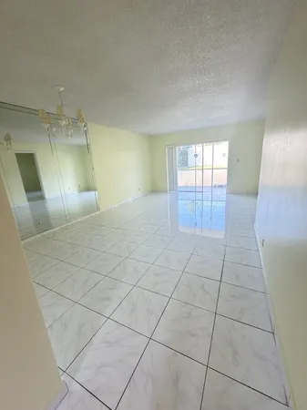 a view of an empty room and a window