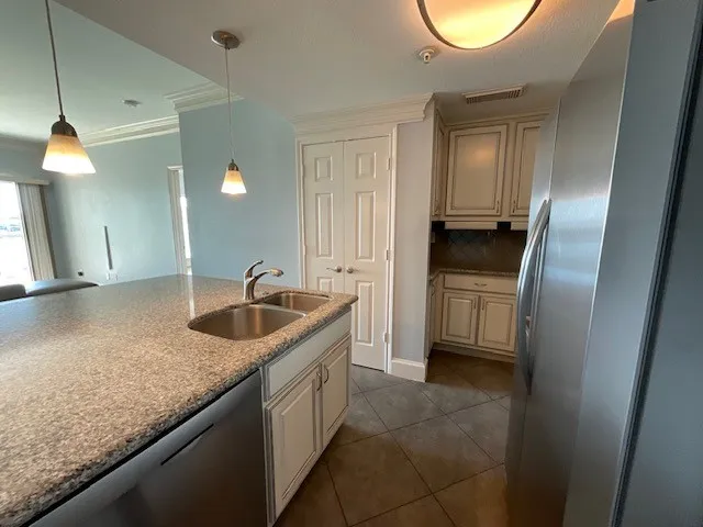 a kitchen with stainless steel appliances granite countertop a sink and a refrigerator