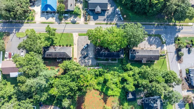 an aerial view of a house with a yard and garden