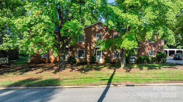 a view of a wooden house and a yard