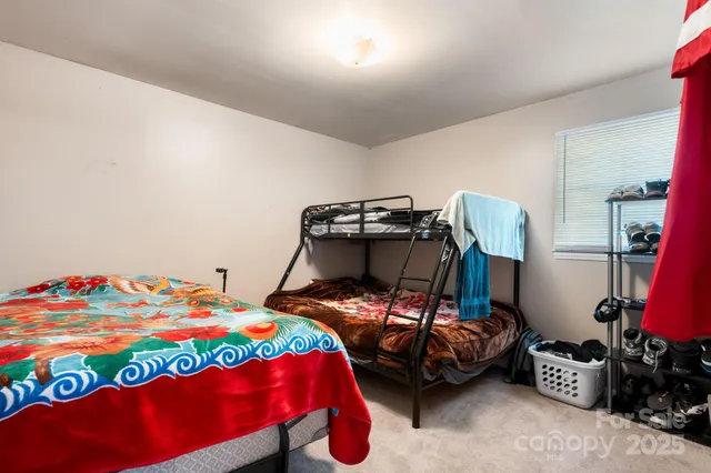 a bedroom with a bed and a lamp