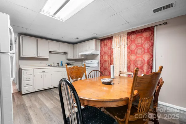 a view of a dining room with furniture and window