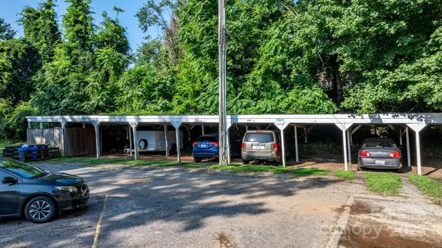 an outdoor view of a house with car parked beside of it