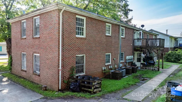 a backyard of a house with barbeque oven and outdoor seating