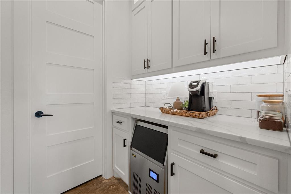 11077 Highway 287, Unit 1 Kerens, TX 75144 - Photo 12 of 40 Bar area featuring light stone counters, white cabinets, and tasteful backsplash