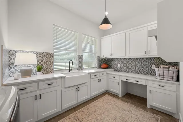 a kitchen with granite countertop white cabinets and white appliances