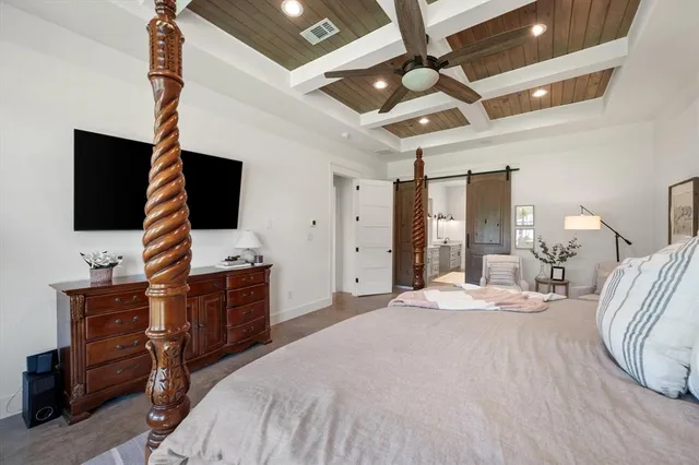 a spacious bedroom with a bed couch and a large window