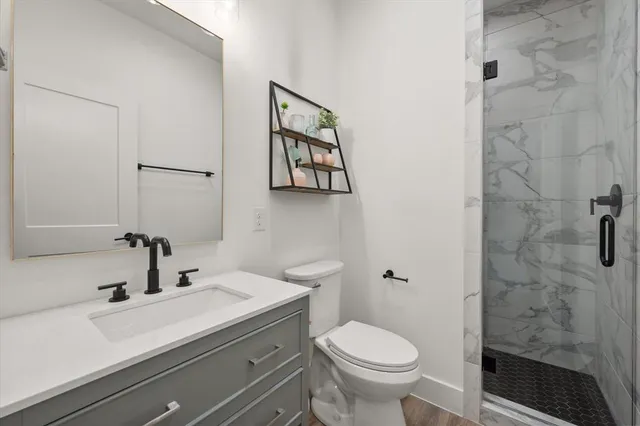 a bathroom with a tub shower and sink