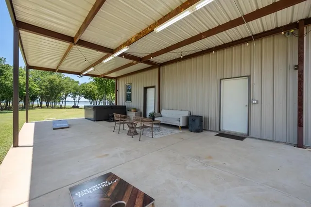 a view of a patio with table and chairs and couches with wooden roof and stairs