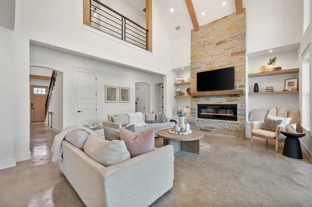 a living room with furniture a fireplace and a flat screen tv
