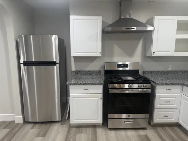 a kitchen with a stove and a refrigerator