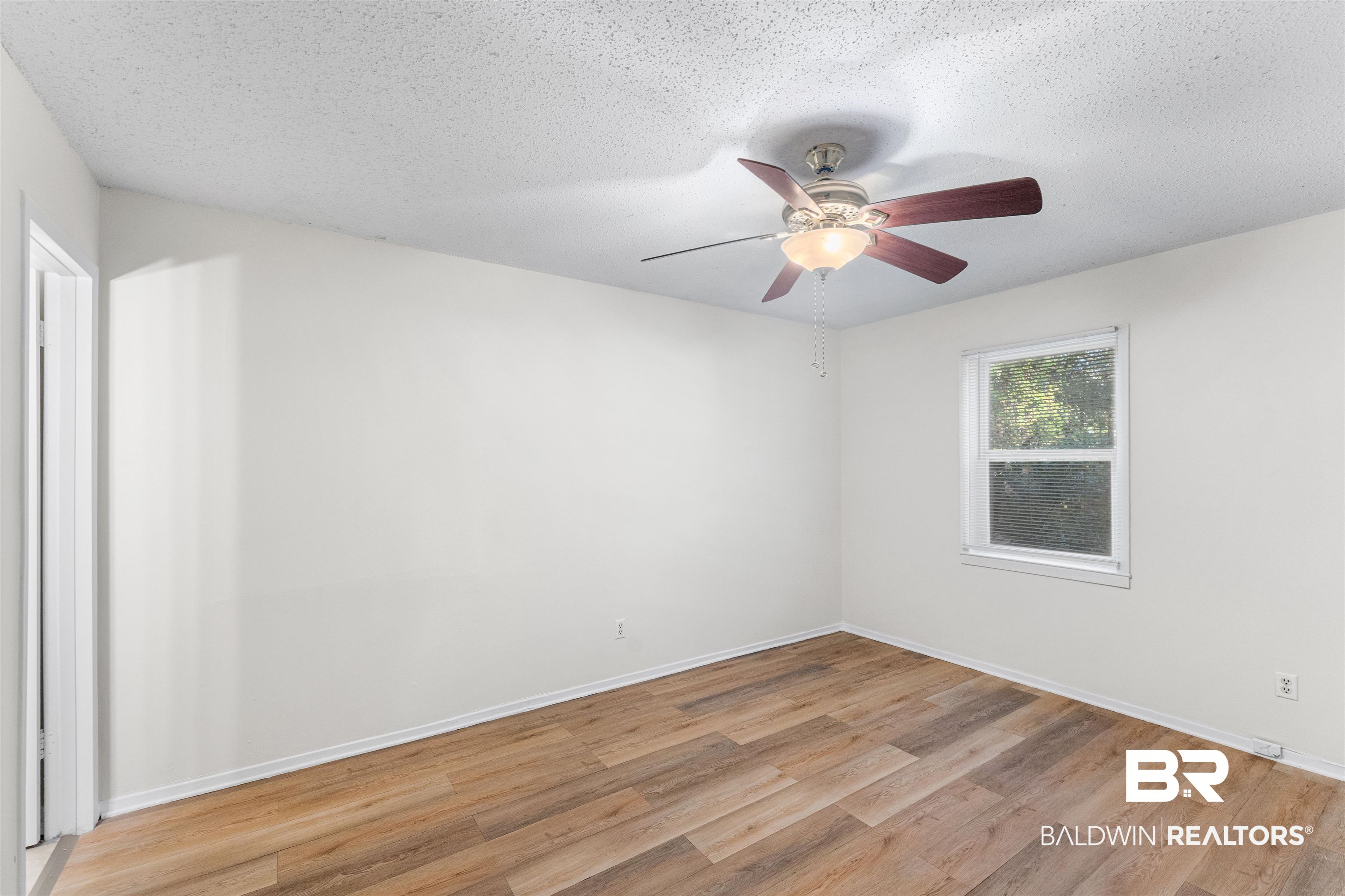 5551 Springer Court Theodore, AL 36582 - Photo 30 of 37 Unfurnished bedroom with ceiling fan, light wood finished floors, and a textured ceiling