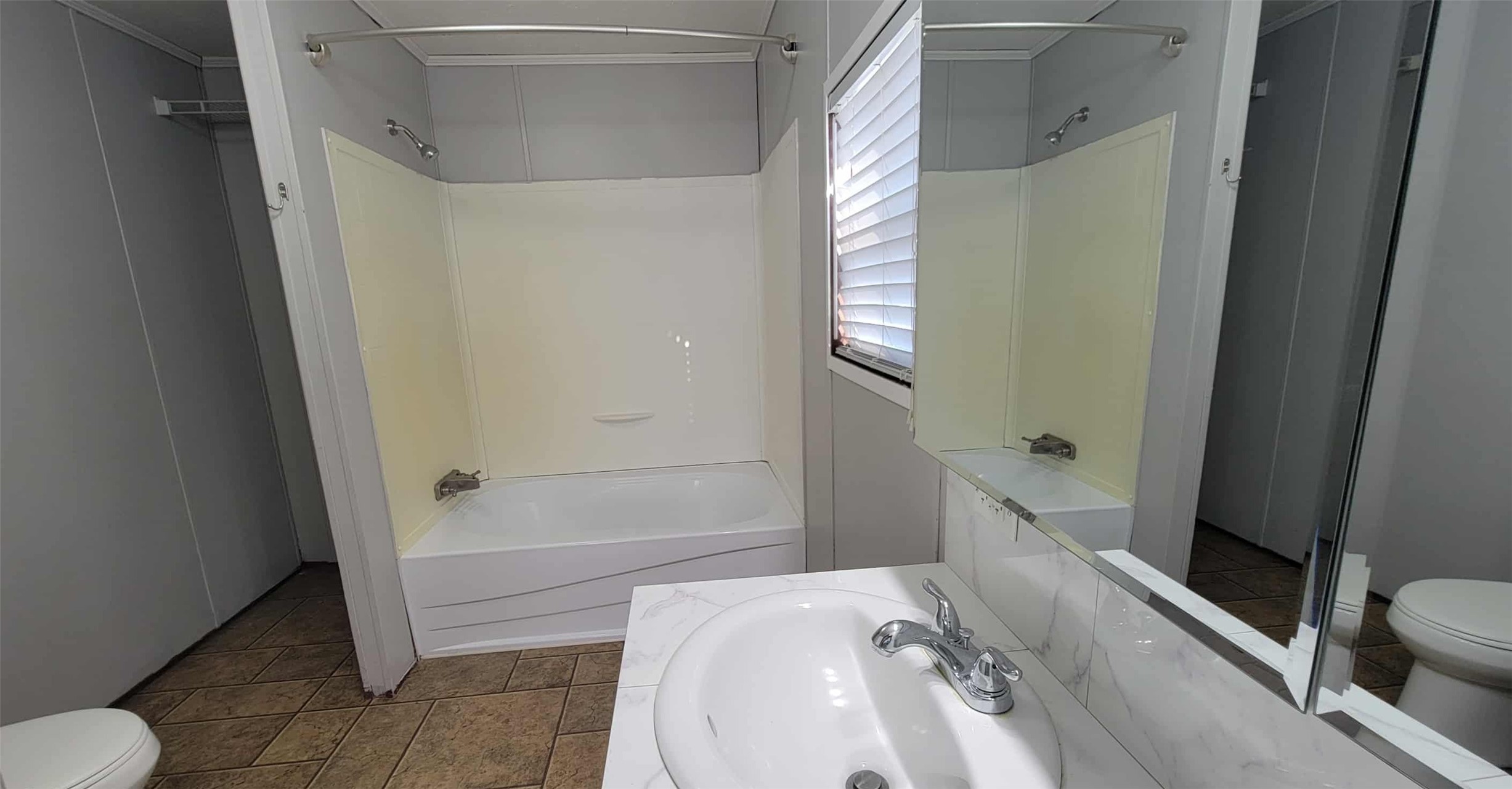 405 Battlebell Road, Unit 2 Highlands, TX 77562 - Photo 12 of 21 a bathroom with a sink a toilet and bathtub