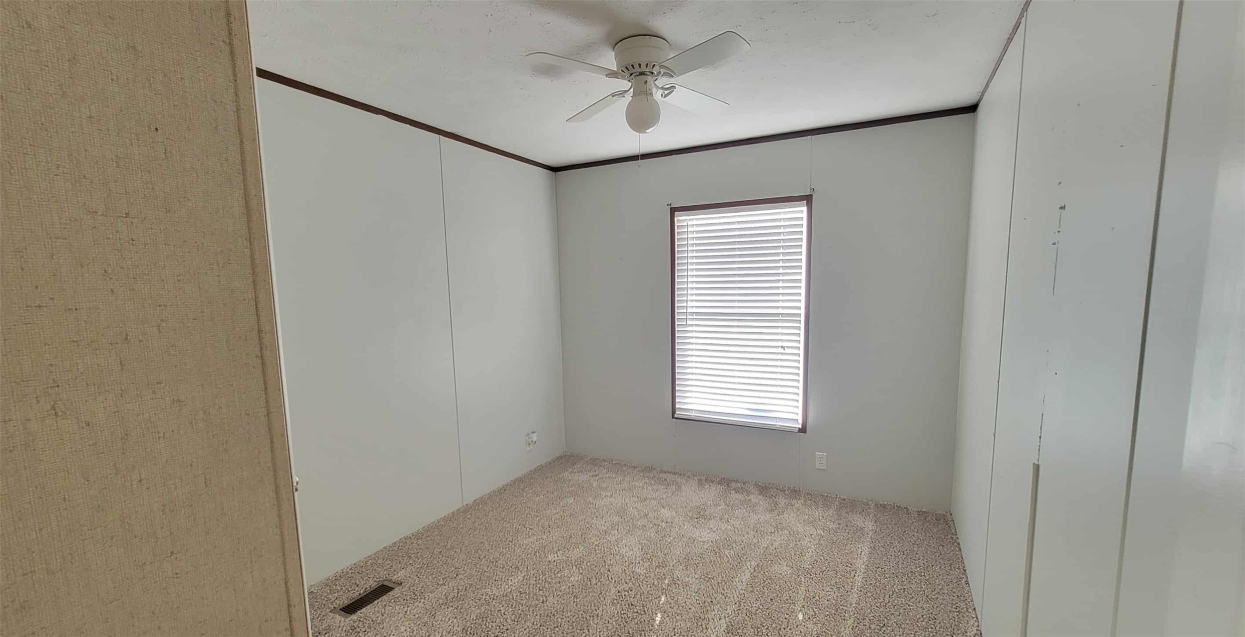 405 Battlebell Road, Unit 2 Highlands, TX 77562 - Photo 14 of 21 an empty room with windows and fan