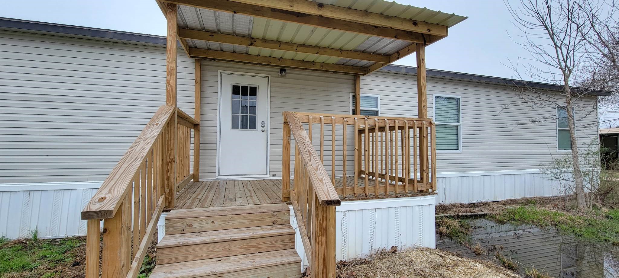 405 Battlebell Road, Unit 2 Highlands, TX 77562 - Photo 19 of 21 a view of a small house with wooden floor and fence