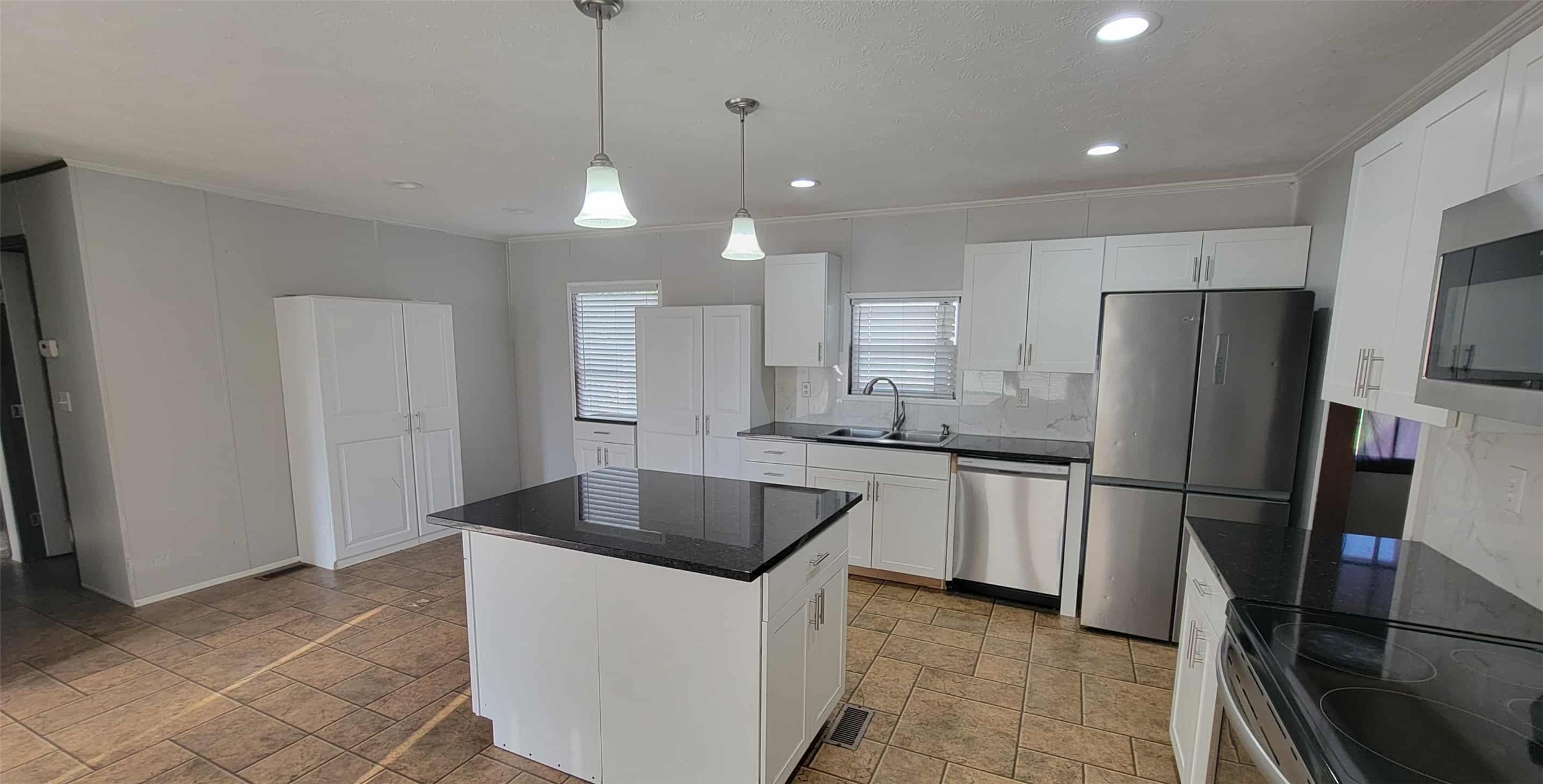 405 Battlebell Road, Unit 2 Highlands, TX 77562 - Photo 5 of 21 a kitchen with stainless steel appliances granite countertop a refrigerator a sink a stove and a refrigerator