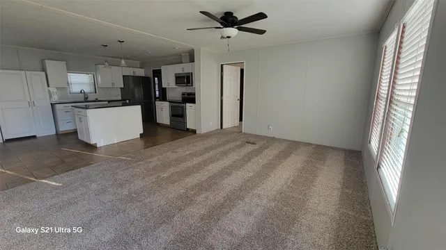 a view of a kitchen with a sink and refrigerator