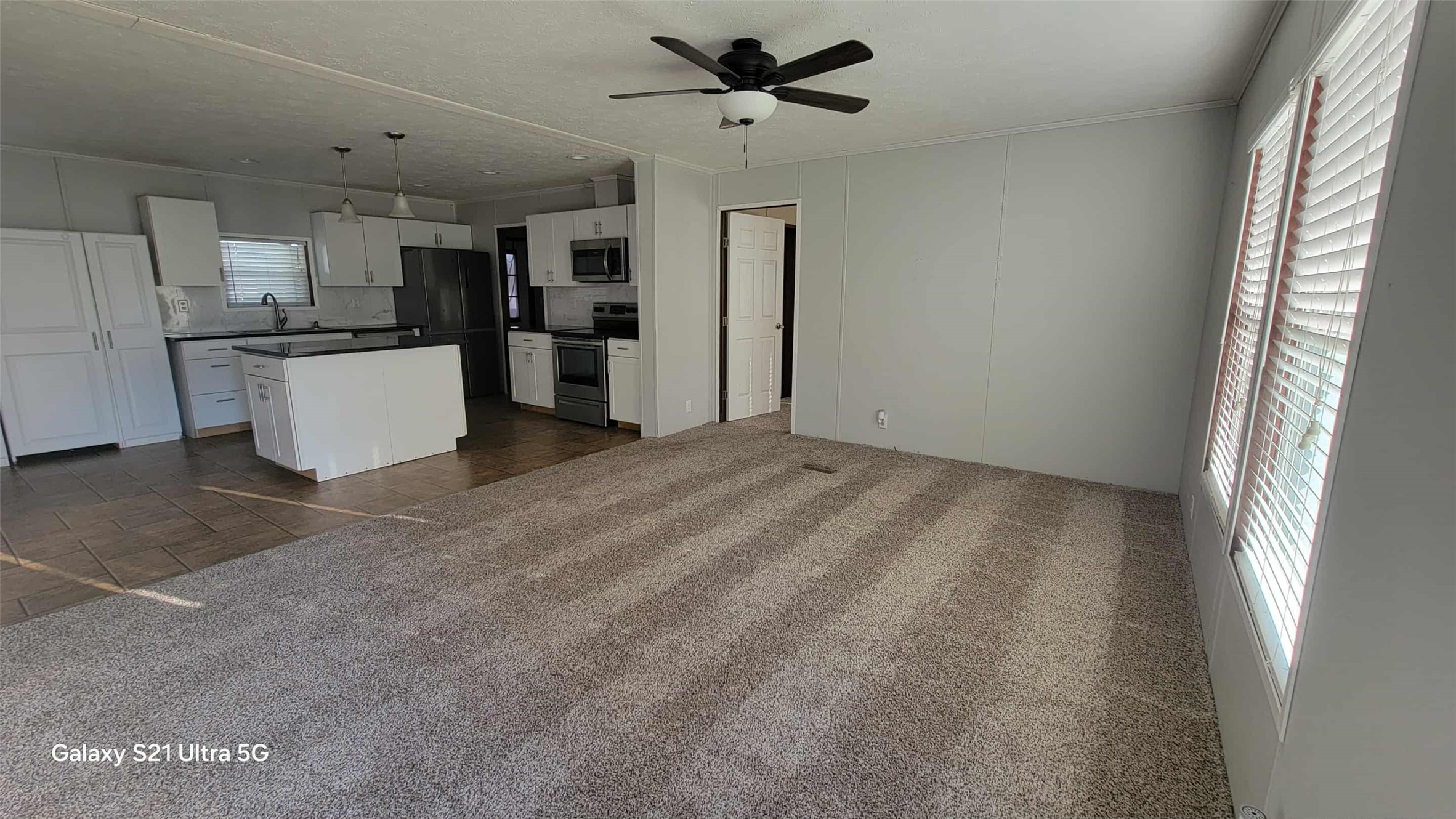 405 Battlebell Road, Unit 2 Highlands, TX 77562 - Photo 6 of 21 a view of a kitchen with a sink and refrigerator