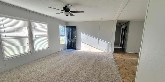 a view of livingroom with a ceiling fan and window
