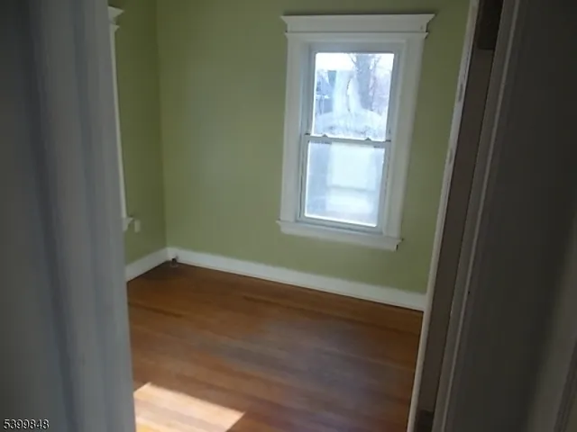 a room with a window and wooden floor