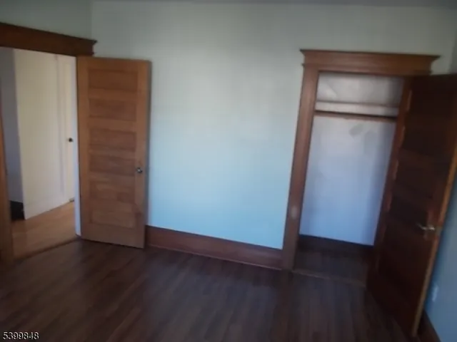 an empty room with wooden floor