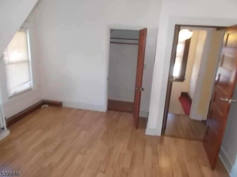104 Riggs Place West Orange, NJ 07052 - Photo 20 of 23 an empty room with wooden floor and glass door