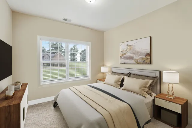 a bedroom with bed and a potted plant