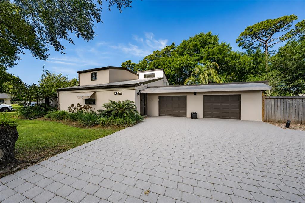 a front view of a house with a yard and a garage