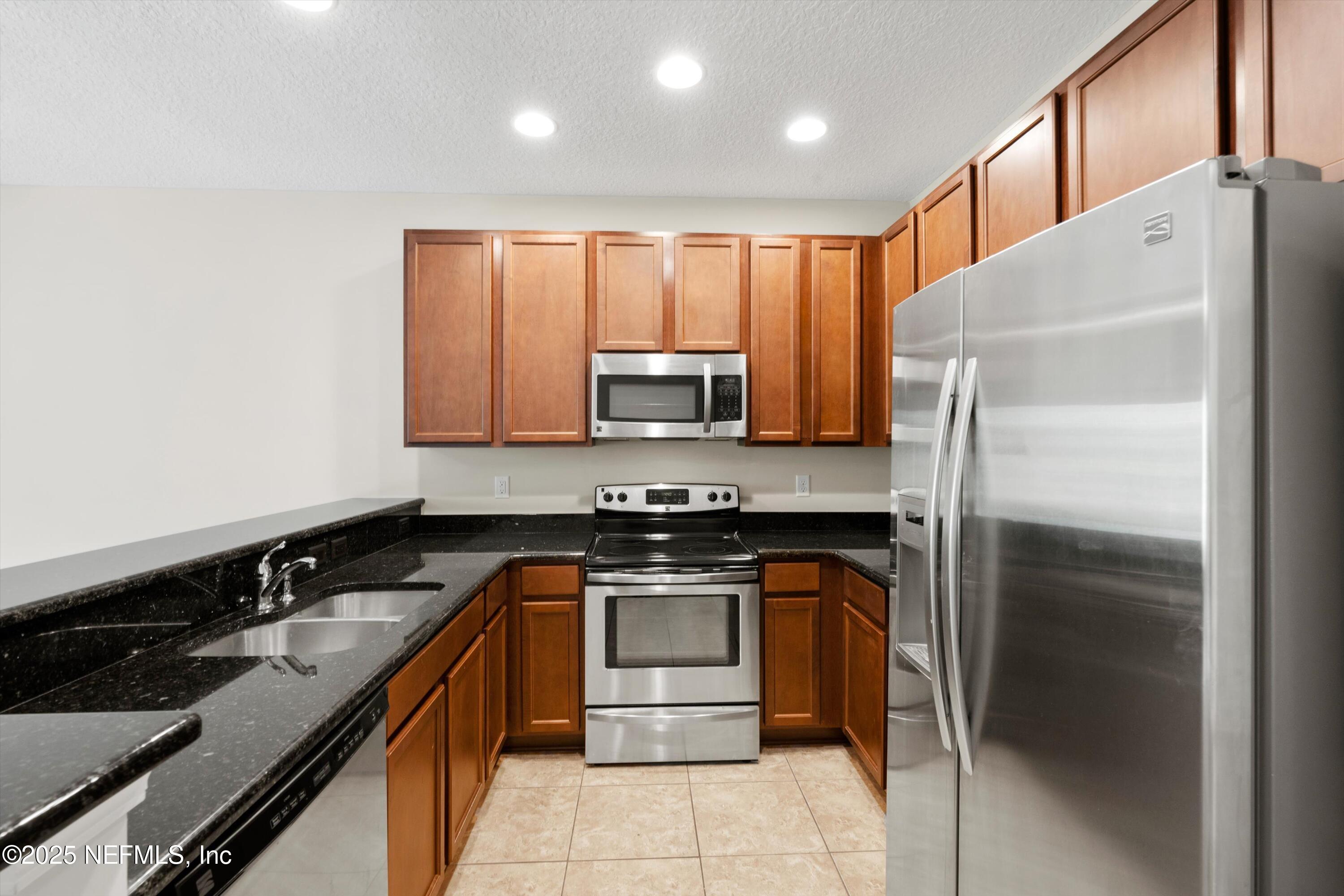 a kitchen with a sink stove and refrigerator