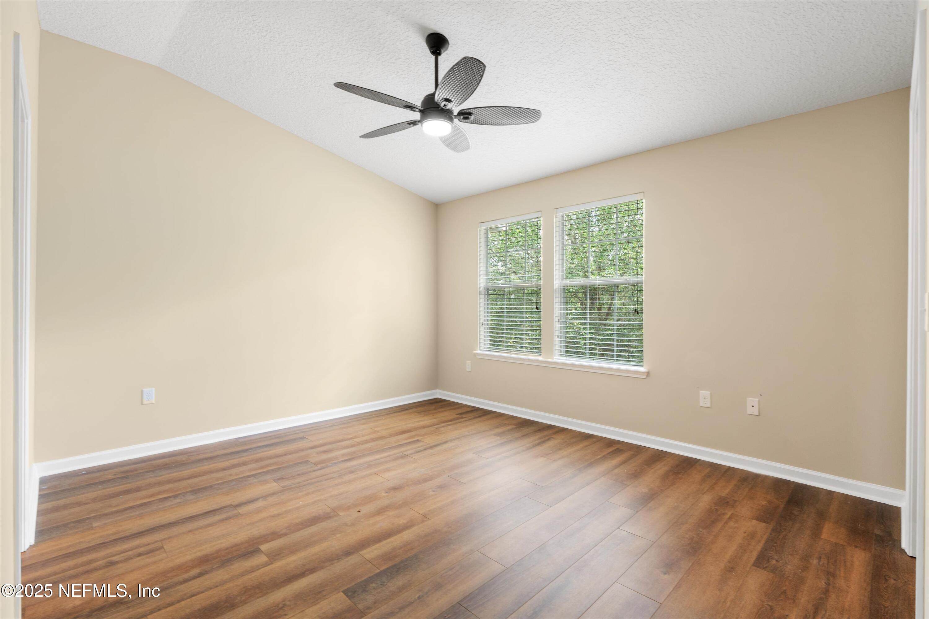 13340 Ocean Mist Drive Jacksonville, FL 32258 - Photo 15 of 25 wooden floor in an empty room with a window