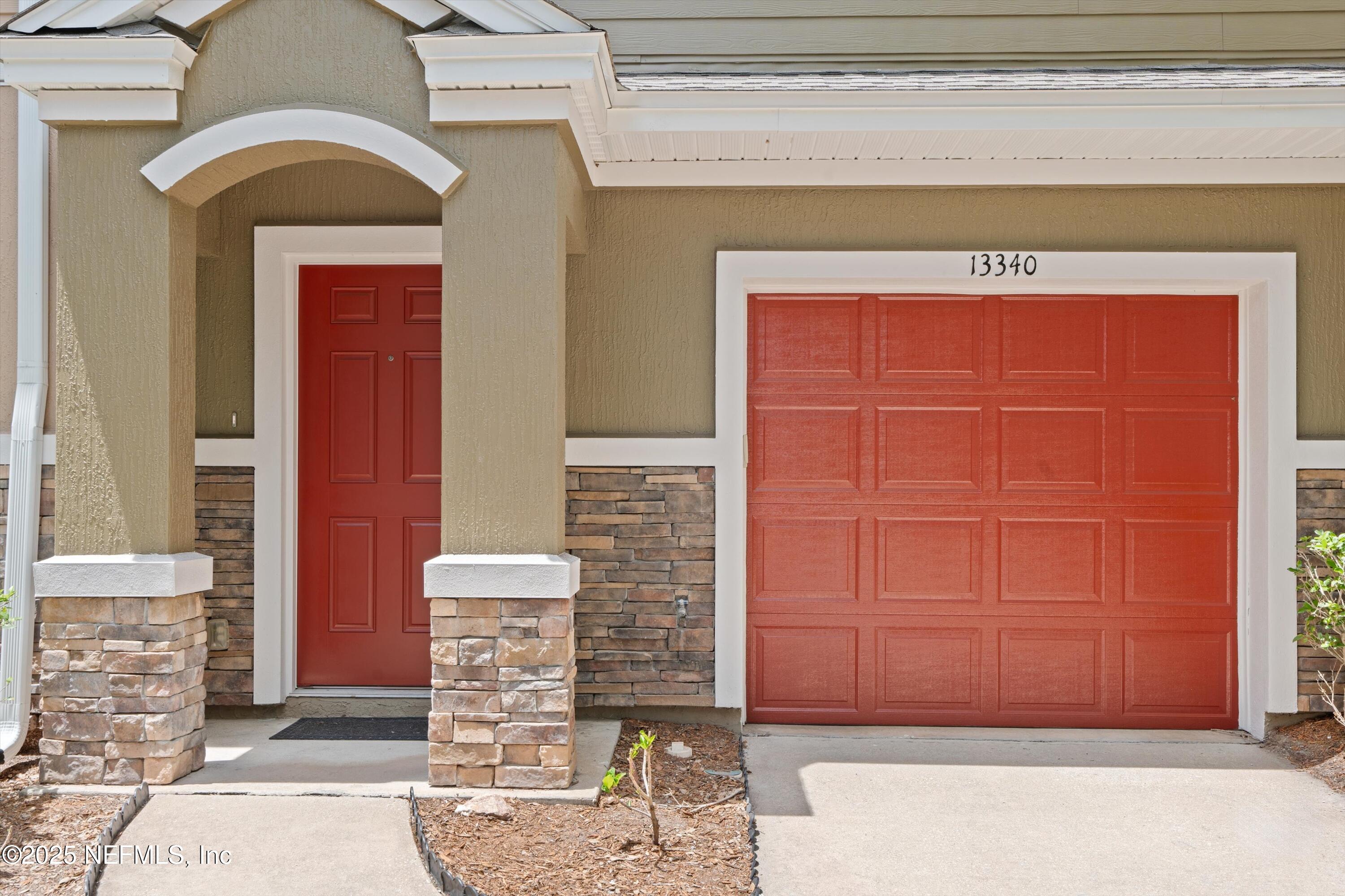 13340 Ocean Mist Drive Jacksonville, FL 32258 - Photo 2 of 25 a front view of a house with a garage
