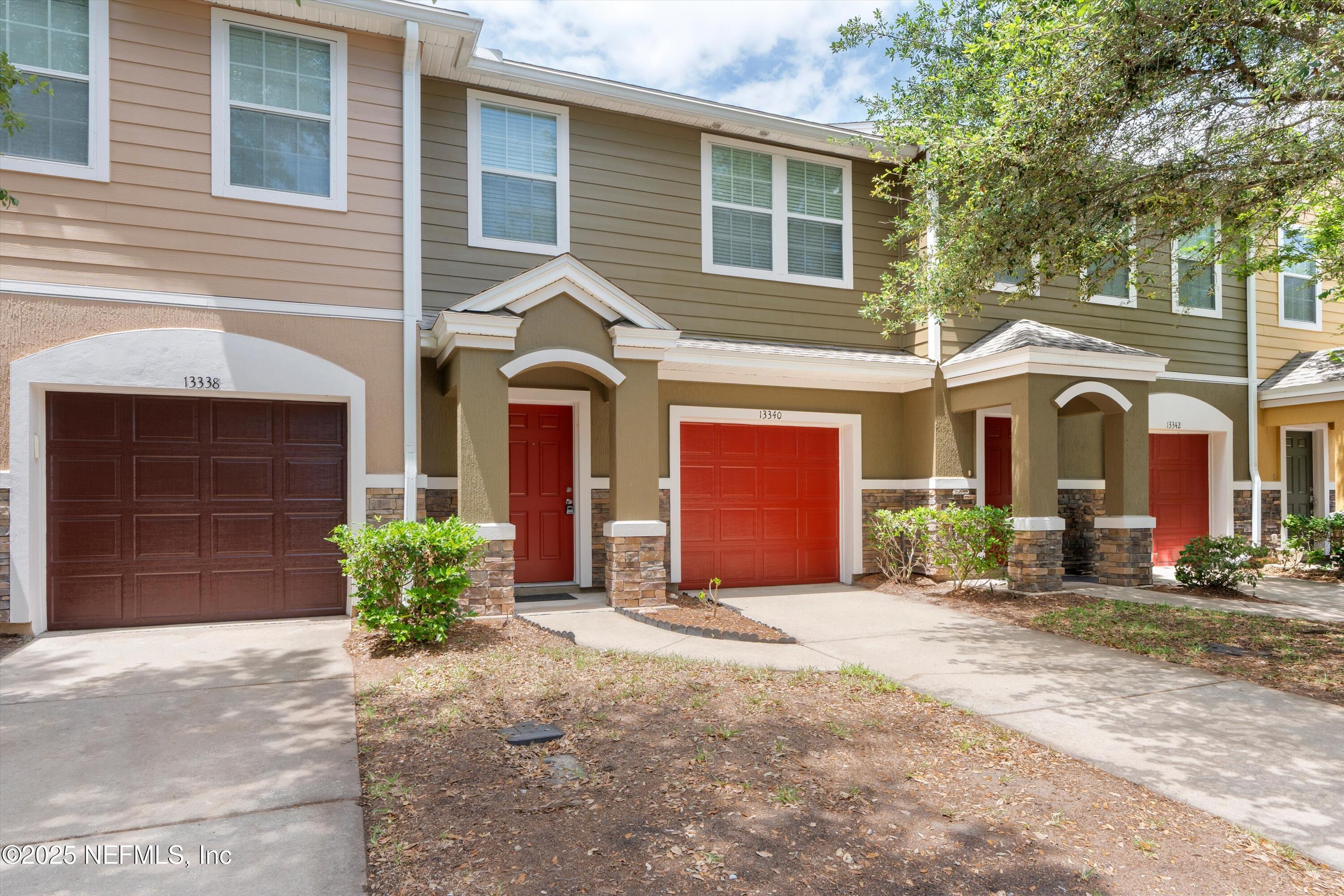 13340 Ocean Mist Drive Jacksonville, FL 32258 - Photo 3 of 25 a front view of a house with glass doors and outdoor space