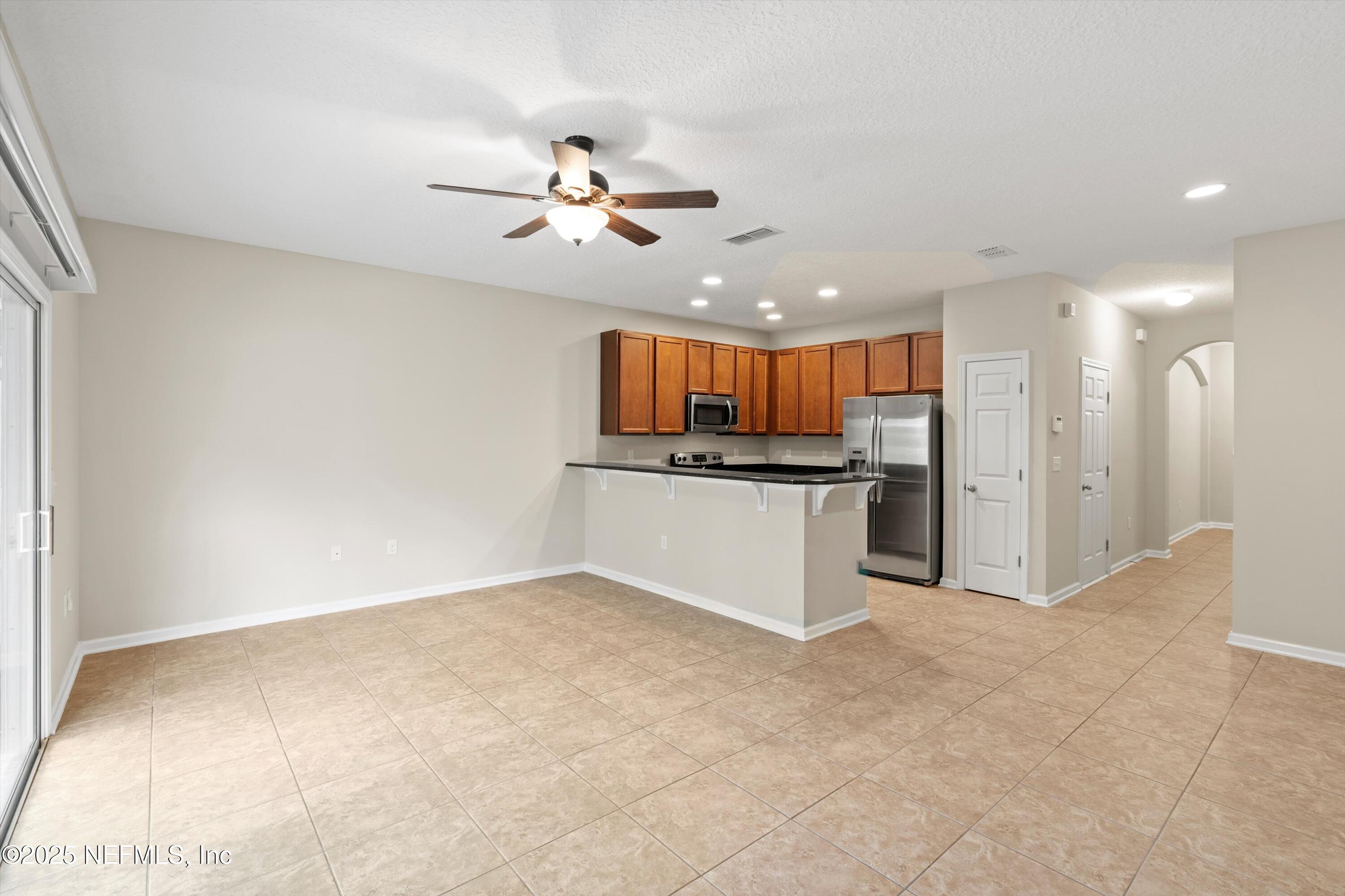 13340 Ocean Mist Drive Jacksonville, FL 32258 - Photo 8 of 25 a large kitchen with cabinets and stainless steel appliances