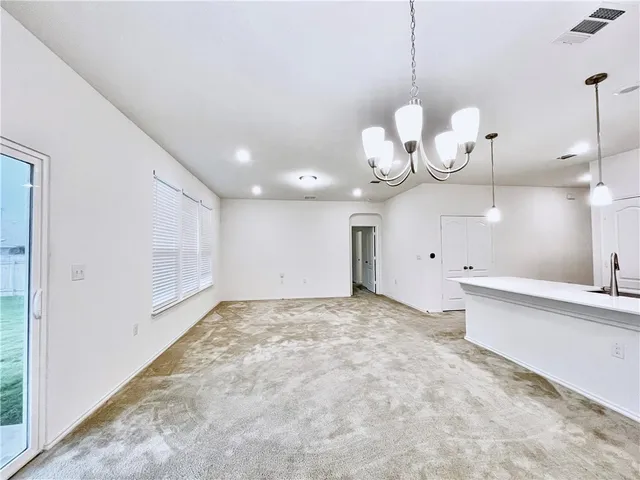 a view of a kitchen with a sink and a chandelier