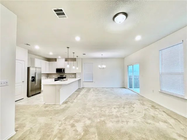 a large kitchen with kitchen island a sink stainless steel appliances and cabinets